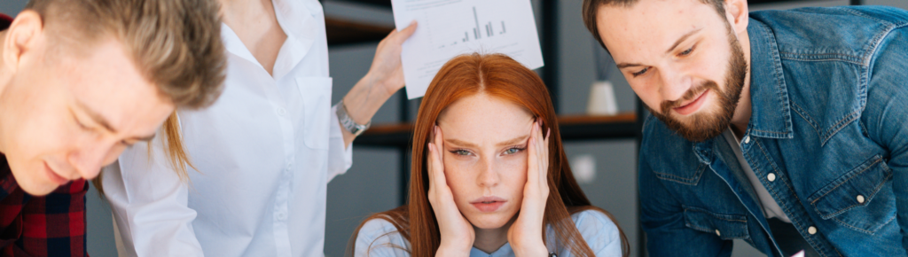 A high-performer overwhelmed by decisions illustrating decision paralysis in a team setting